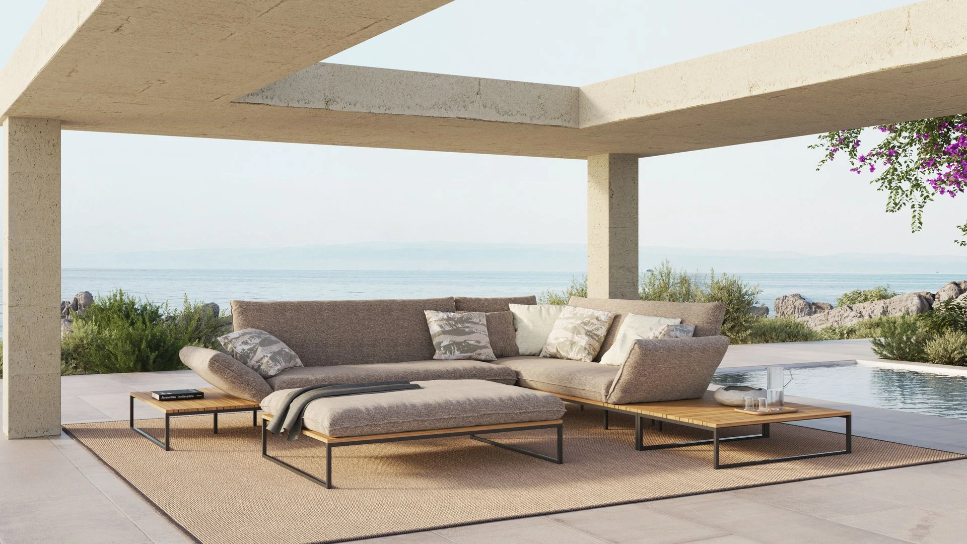 Exklusive Flora Lounge-Landschaft von Fischer Möbel auf einer luxuriösen Terrasse mit Meerblick und moderner Beton-Architektur.